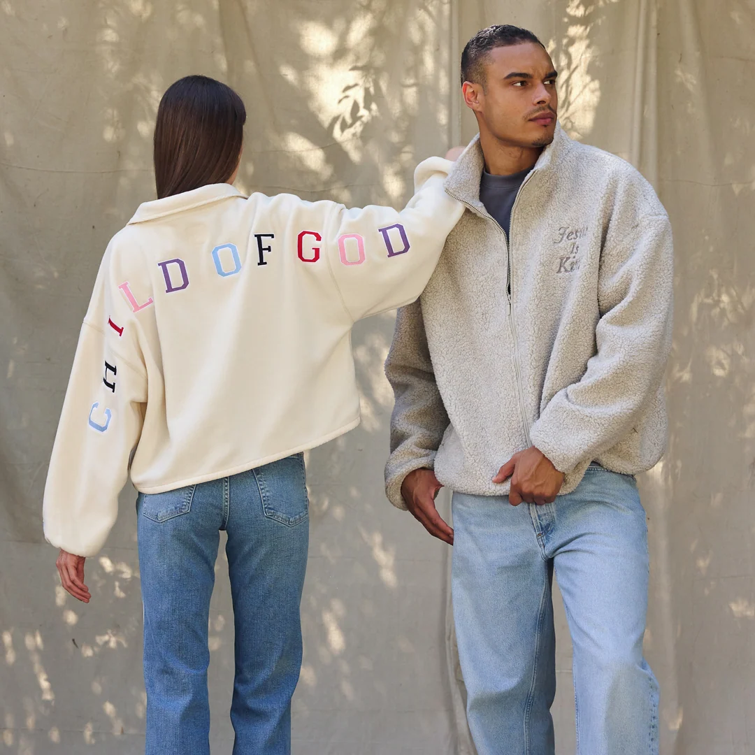 Two people wearing Elevated Faith fleece, photographed in natural light